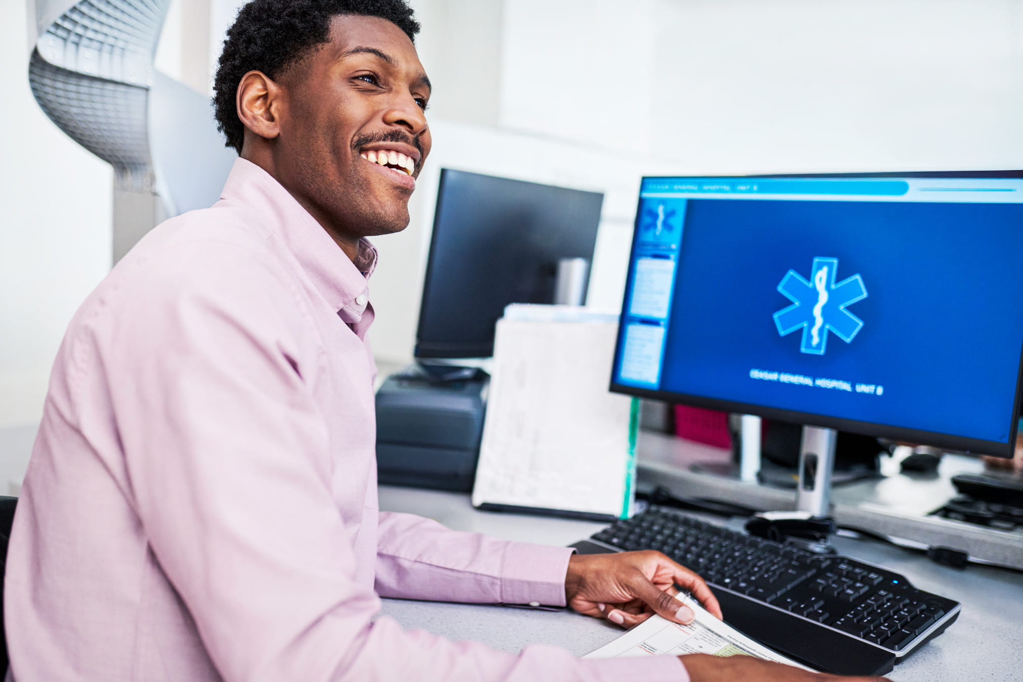 Smiling pharmacist working on a computer