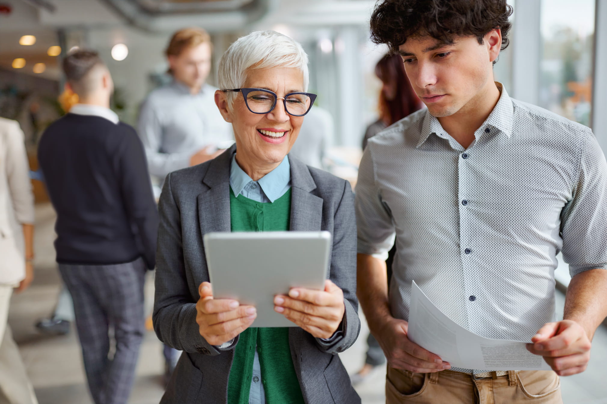two people looking at the digital information on a tablet