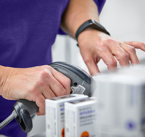 Close up of a pharmacist scanning drugs
