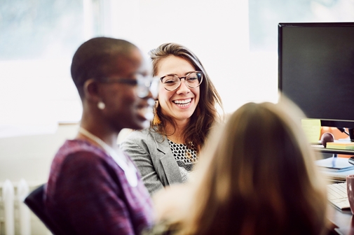 Cencora coworkers discussing and laughing in office 