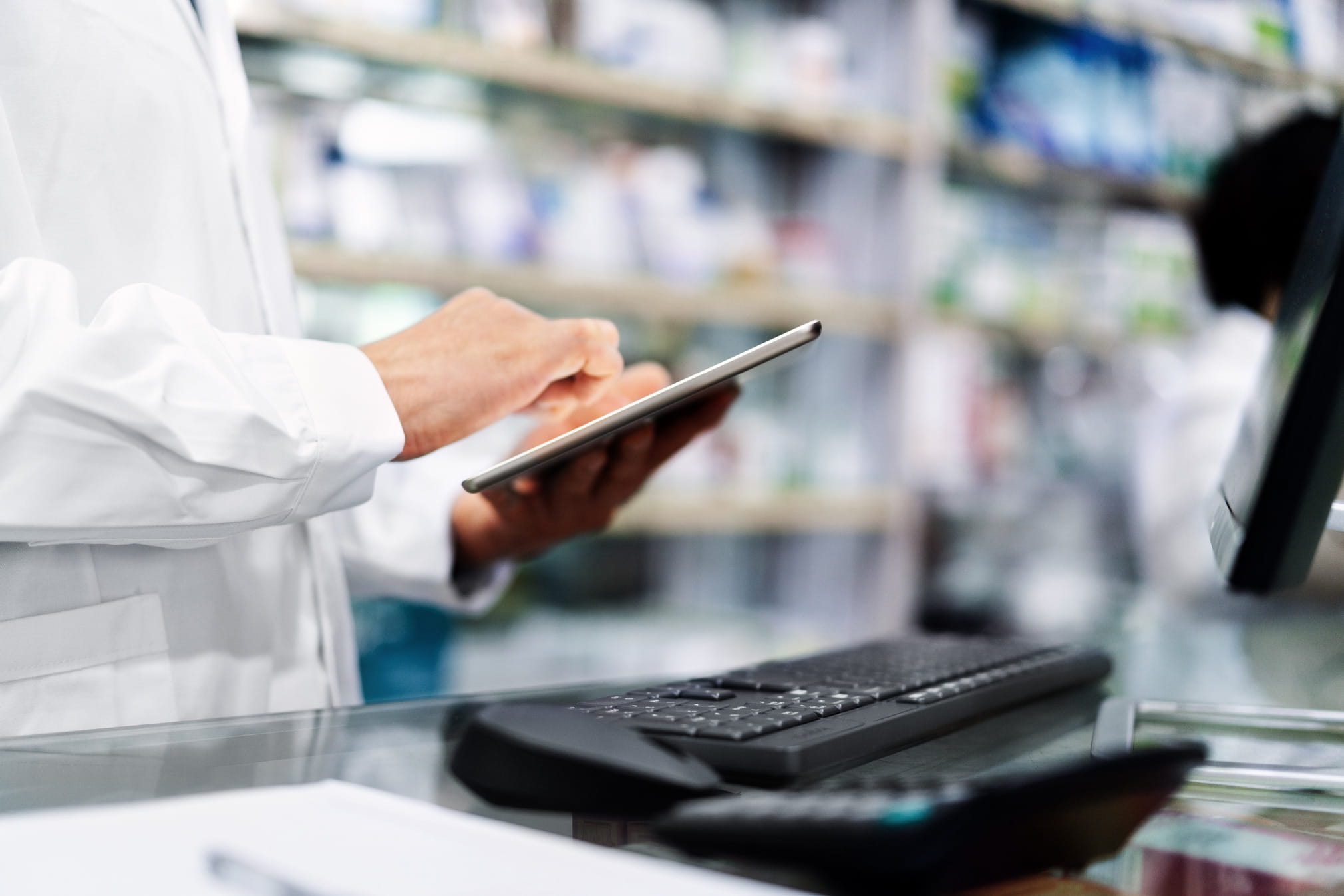 Pharmacist typing on a tablet