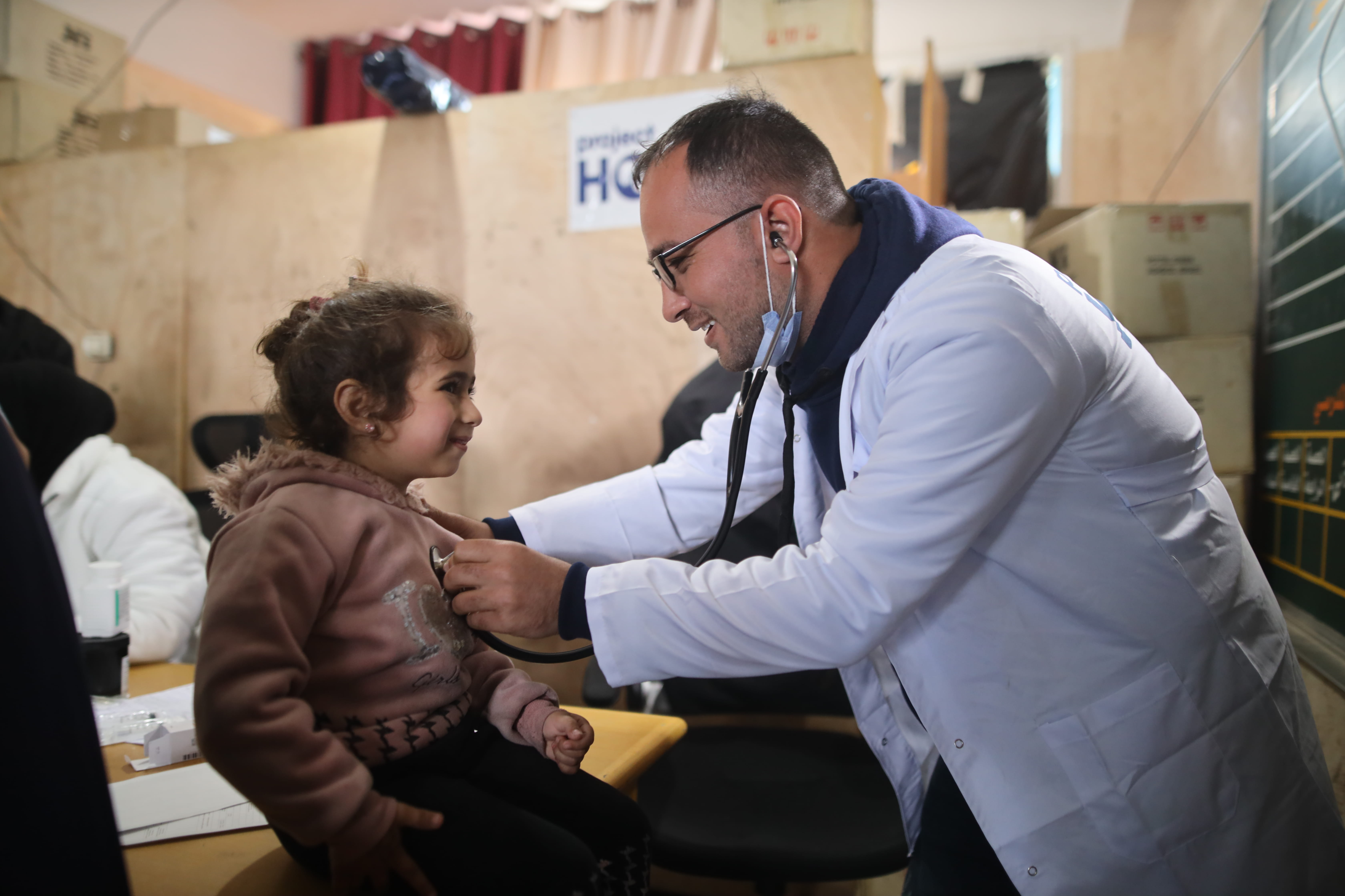 Doctor examining little girl in the outside setting