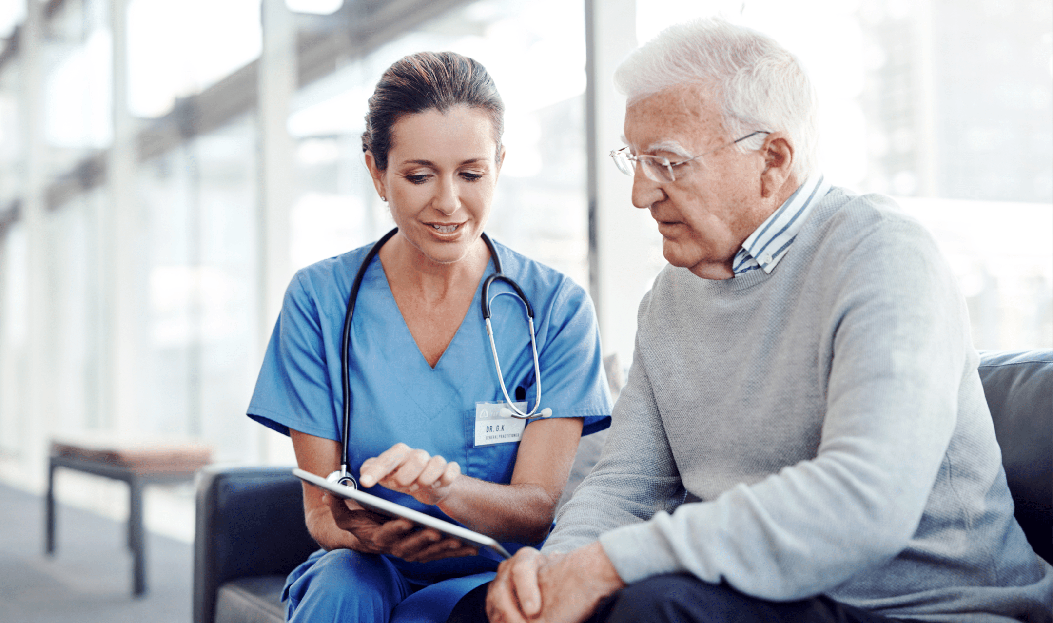Nurse showing and explaining medical documents to an older man.