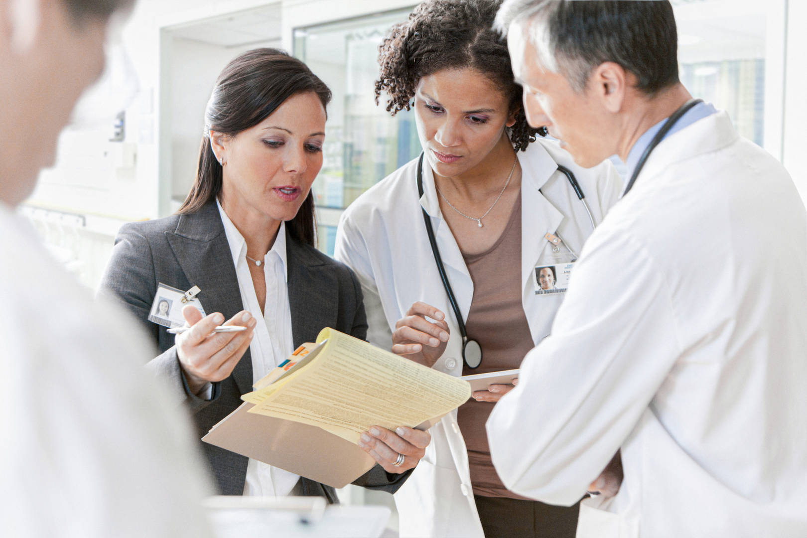 A business woman in a meeting with physicians.