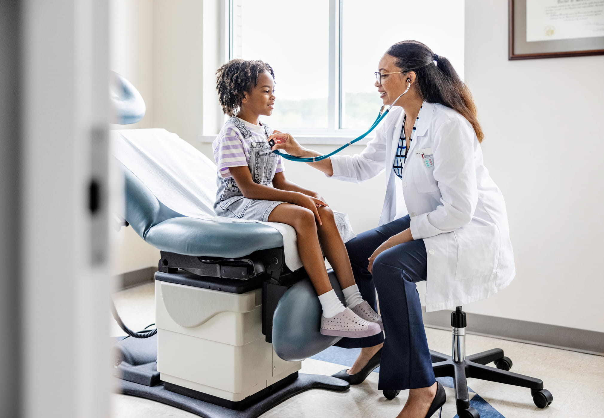 Doctor checking the health of a young patient