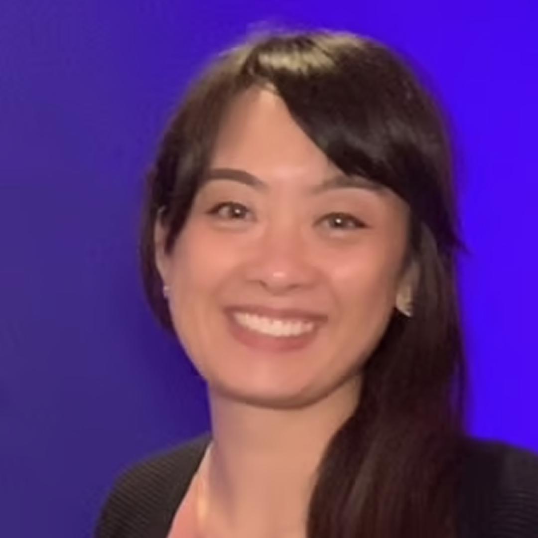 A headshot of a Senior Strategic Business Analyst at Cencora, a young woman with long brown hair with curtain bangs, and a slight smile, dressed black conveying leadership and professionalism.