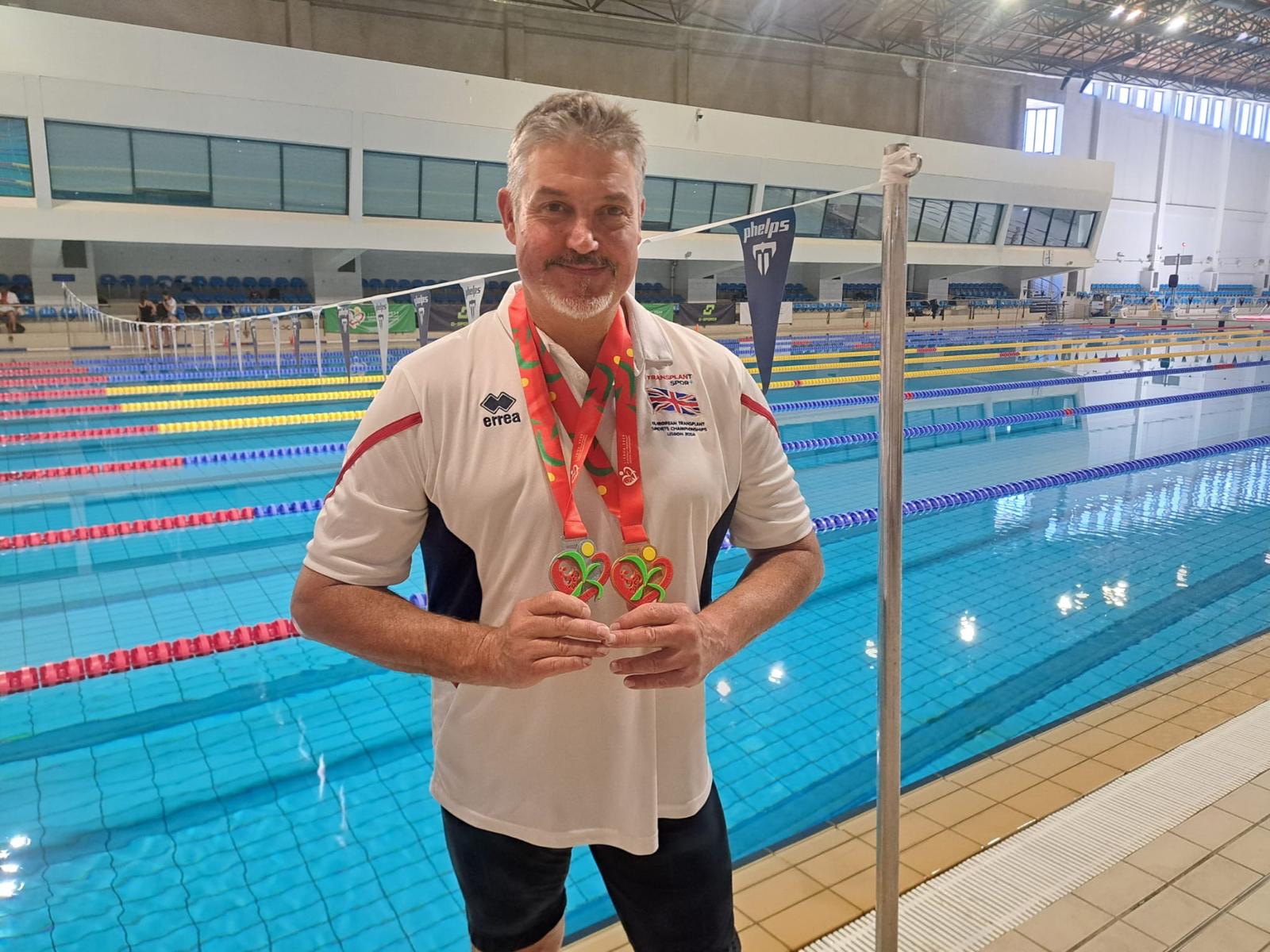 Alliance Healthcare team member Fran Middleton with his medals from the European Transplant Sport Championships