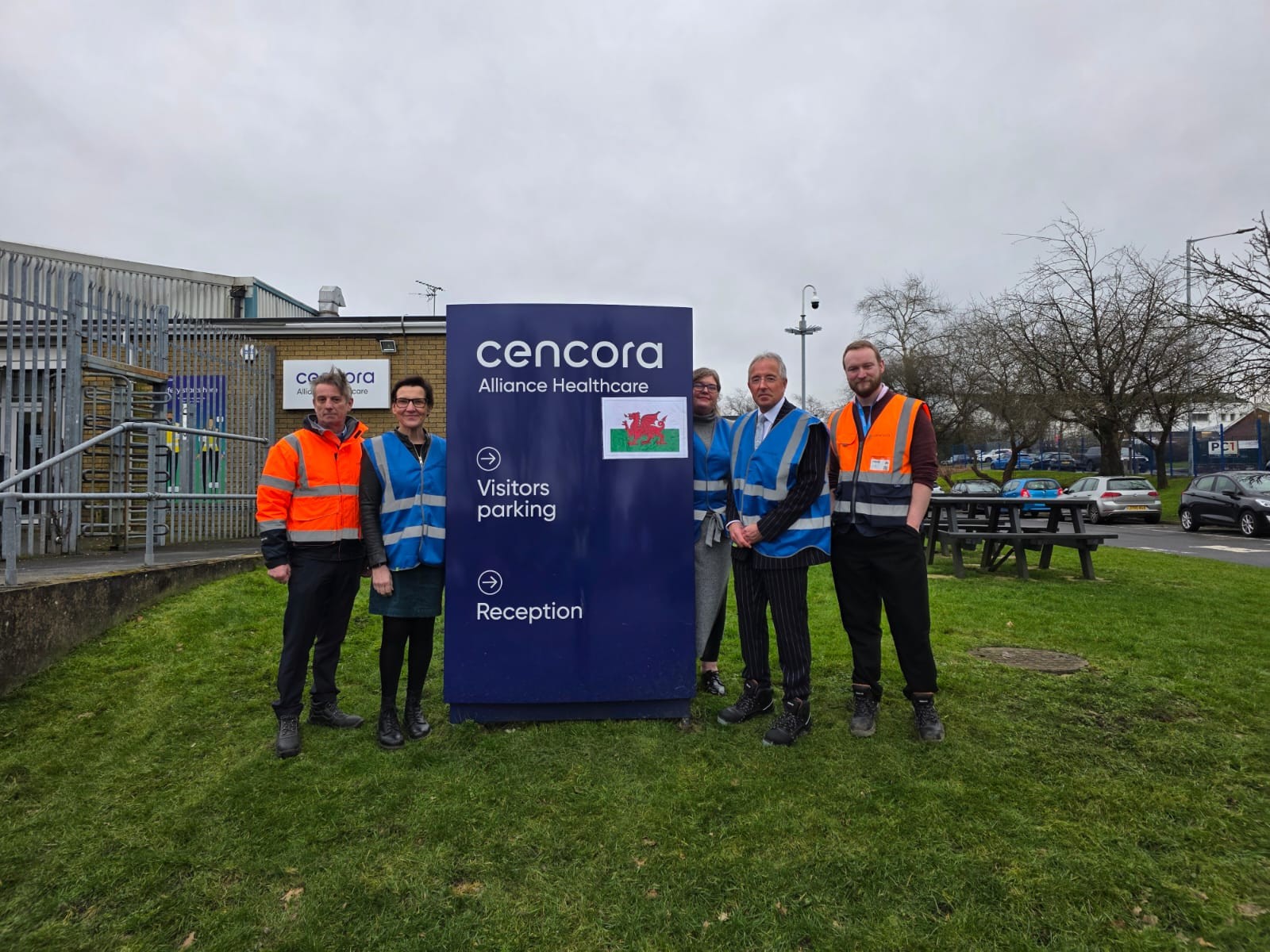 Tonia Antoniazzi MP with the Alliance Healthcare team by the Swansea Service Centre sign