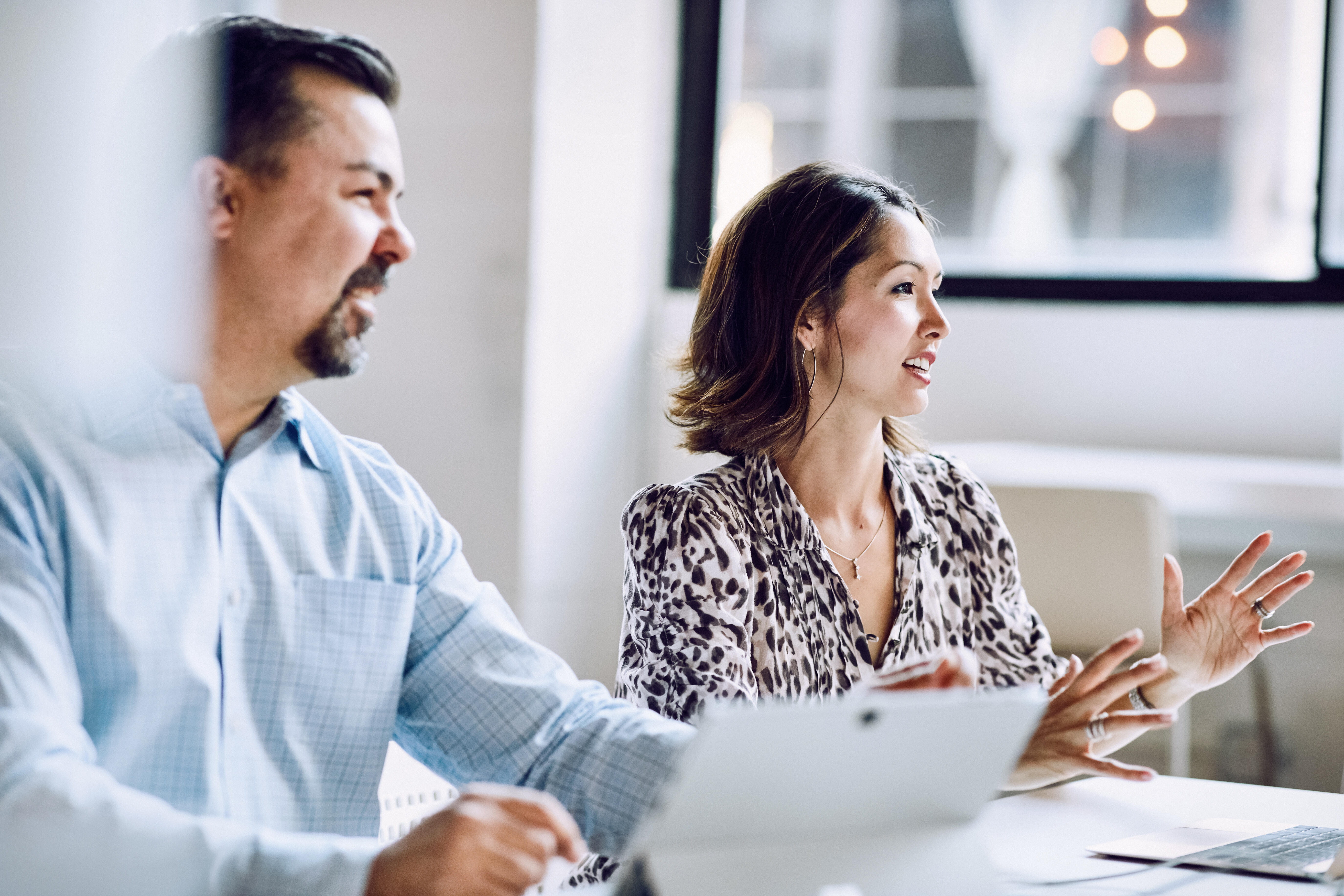 Male and female coworker at conference table