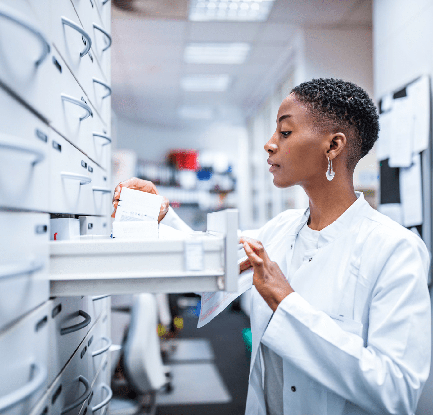 Pharmacists is looking at the pharmacy drawer