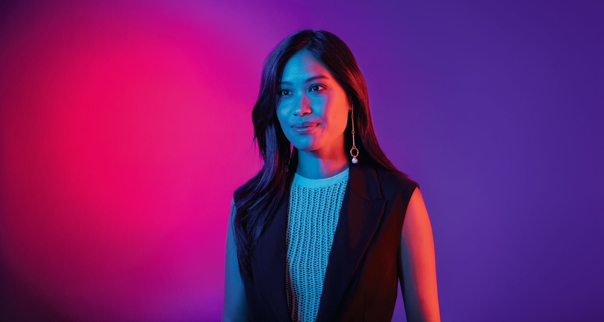 Woman standing in red-purple background