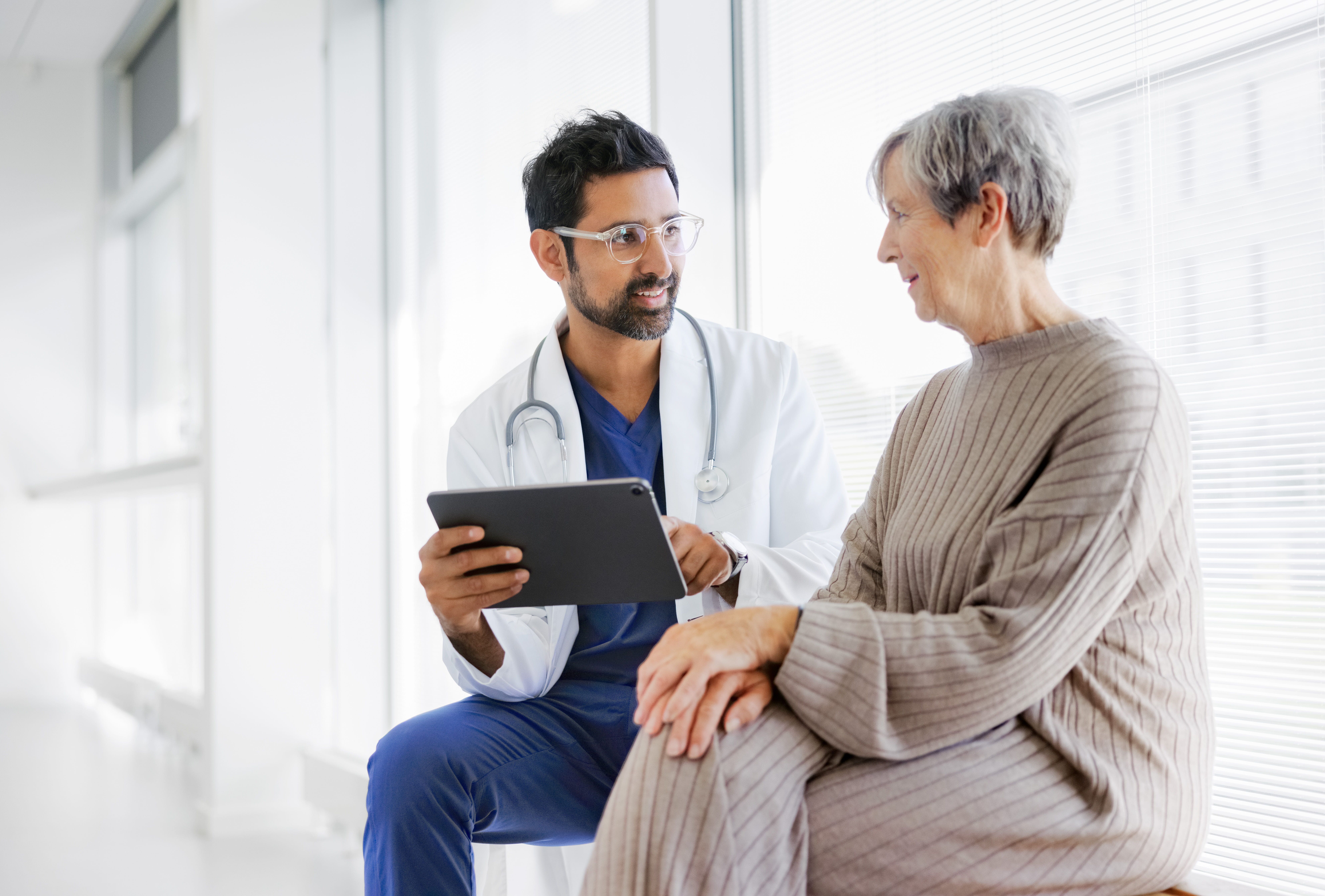 doctor looking at screen with patient