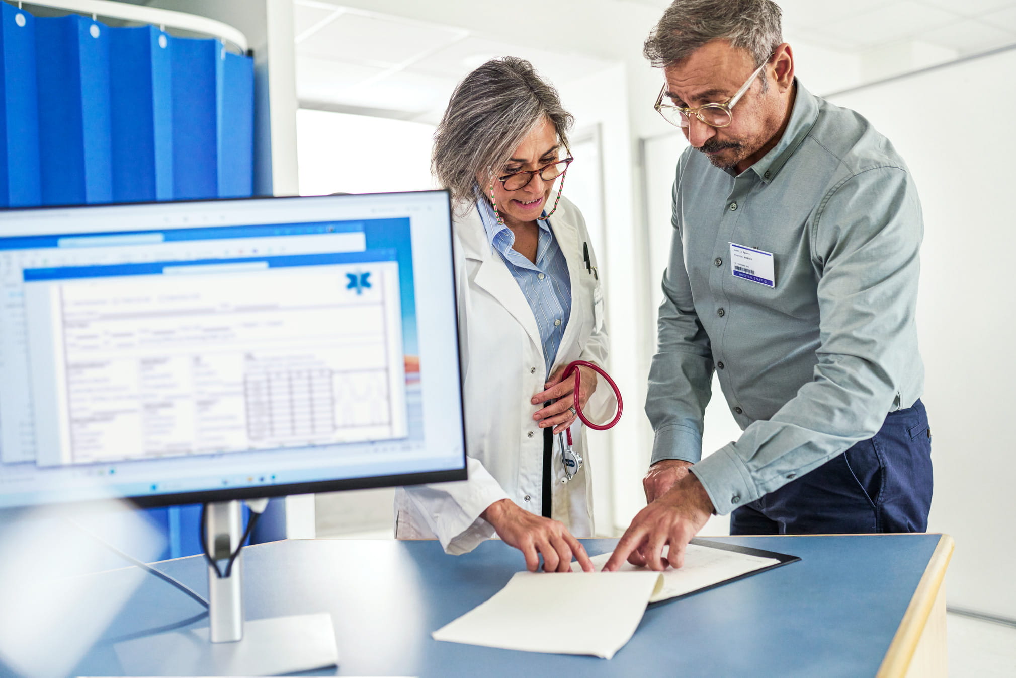 Clinicians collaborating on cancer care delivery.
