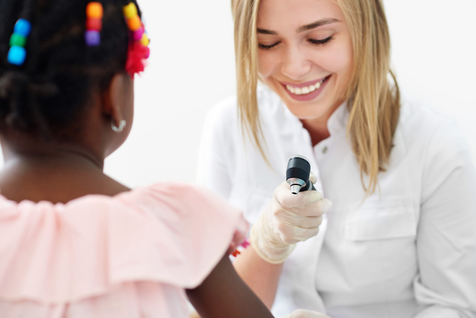 Female doctor delivering pediatric care.