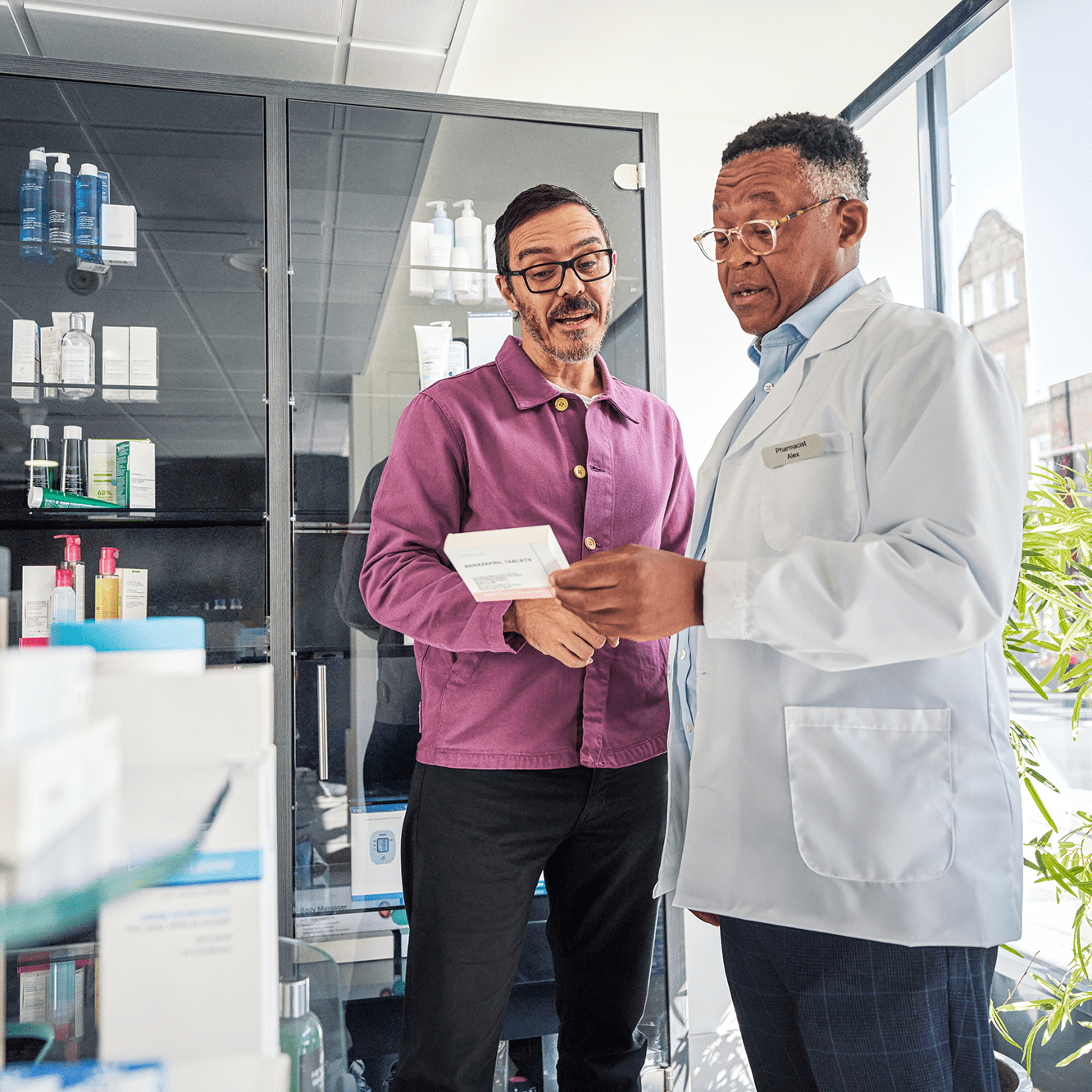Doctor shows a drug to a patient while speaking